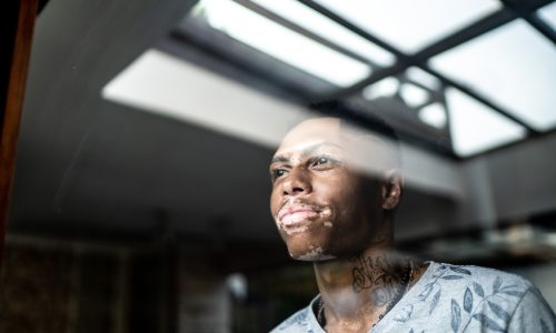 Young man looking through the window